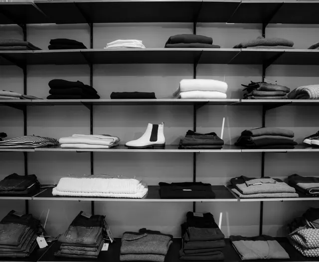Neat stacks of folded clothes on boutique shelves