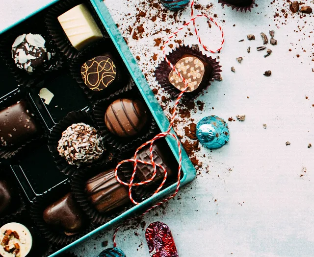Assorted chocolate truffles and bonbons on a dark surface